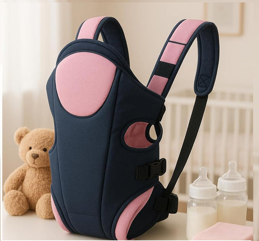 Black and pink baby carrier with teddy bear and bottles in the background, comfortable and ergonomic infant carrier